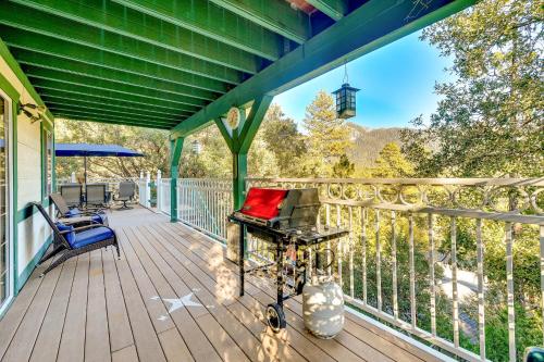 a large deck with a table and chairs on it at Spacious Idyllwild Home with Mountain Views! in Idyllwild