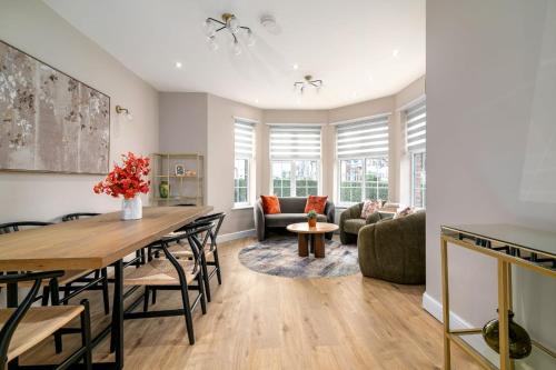 a kitchen and living room with a table and chairs at The golden place in London