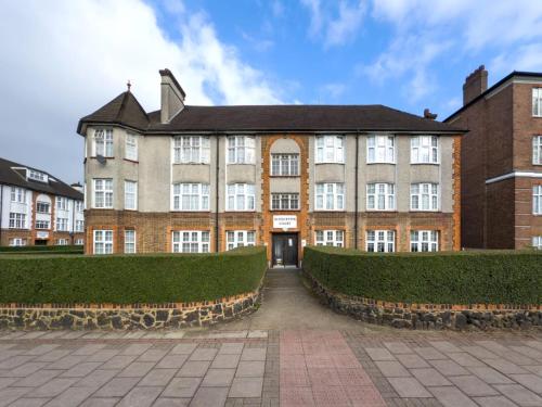 a large brick building with a pathway in front of it at The golden place in London