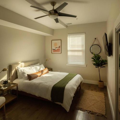 a bedroom with a bed with a ceiling fan at Downtown, contemporary, 2 bedroom, Roof Terrace! 2B in Savannah