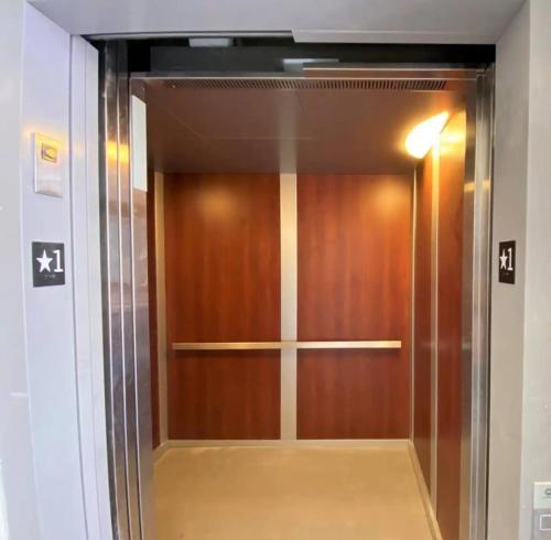 a wooden elevator door in a building at Downtown, contemporary, 2 bedroom, Roof Terrace! 2B in Savannah