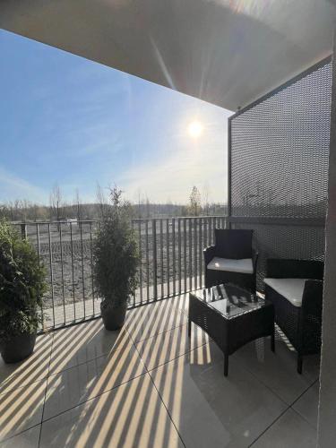 a balcony with a couch and a coffee table at New BNB Apartment In the Ostrava with parking option in Slezská Ostrava