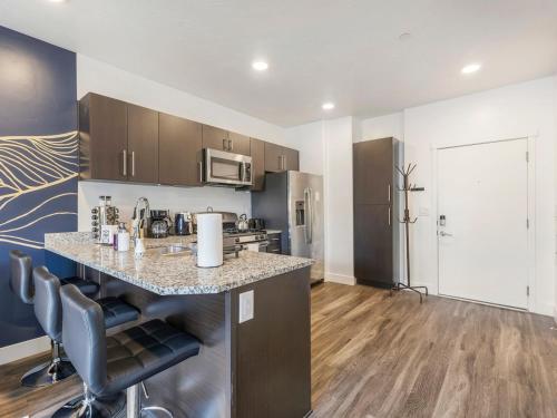 a kitchen with a counter top in a room at Downtown SLC Apartment - King Bed - Gym - Smart TV in Salt Lake City