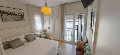 a bedroom with a bed in a room with windows at LUXURY VILLA ZAGARA GOLF & Pool in Estepona