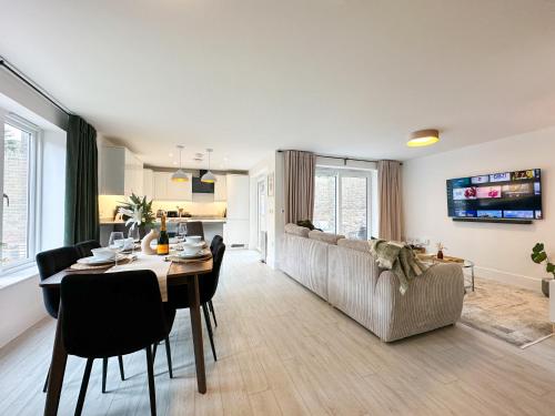 a living room with a table and a couch at NEW Edwin Bing Mews -Luxury City Centre Home - FREE Parking in Canterbury