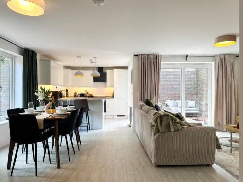 a living room and kitchen with a table and a couch at NEW Edwin Bing Mews -Luxury City Centre Home - FREE Parking in Canterbury