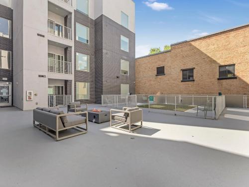 an empty courtyard in a building with two chairs at City Center Apartment - King Bed - Gym - Smart TV in Salt Lake City