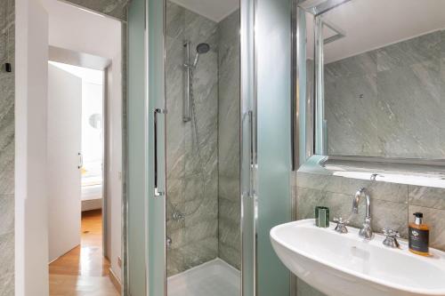a bathroom with a sink and a shower at Heart Milan Apartments San Sepolcro Duomo in Milan