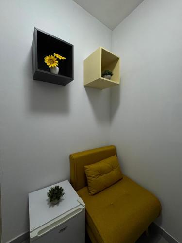 a room with a chair and a tv on the wall at Pozzuoli Seaview in Pozzuoli