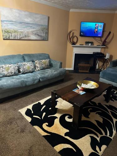a living room with a couch and a coffee table at #Cozy2BR Near Stonecrest Stone MTN Park in Lithonia