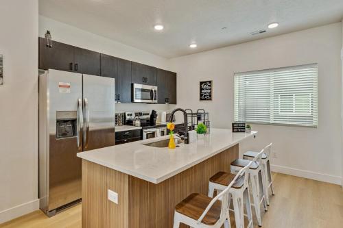 a kitchen with a large counter with a refrigerator at Spacious townhouse - Mins to Downtown SLC - Garage in Salt Lake City