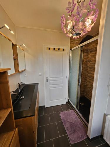 a kitchen with a white door and a chandelier at Grande maison proche de Chambord et de la Loire in Saint Laurent Nouan
