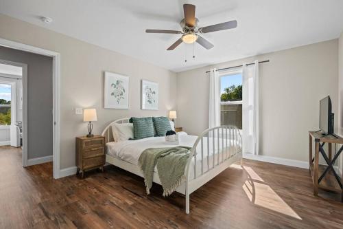 a bedroom with a bed and a ceiling fan at Open w Water & Power- 10 min to Asheville! in Asheville