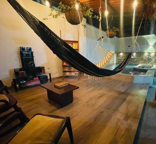 a room with a hammock in the middle of it at Casa Hostal los Profes in Mocoa