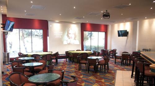 a restaurant with tables and chairs in a room at Casa Grande Chihuahua in Chihuahua