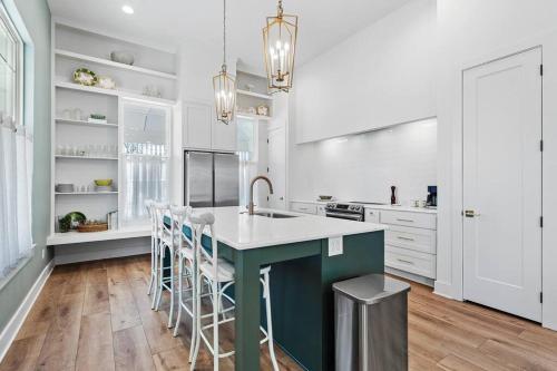 a kitchen with a green island and white cabinets at Gloria Estate- 2 blocks to Silos in Waco