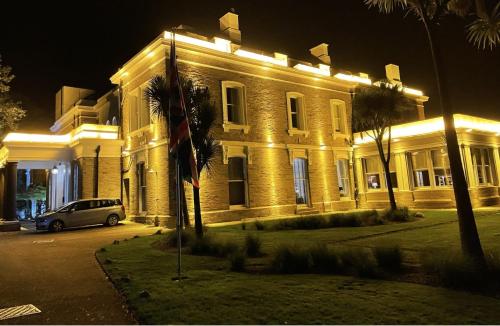 a building with a car parked in front of it at night at Trenython Manor Resort in Fowey