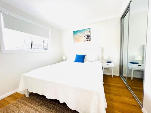 a white bedroom with a white bed and a desk at Private & Cozy villa for you! in Sutherland