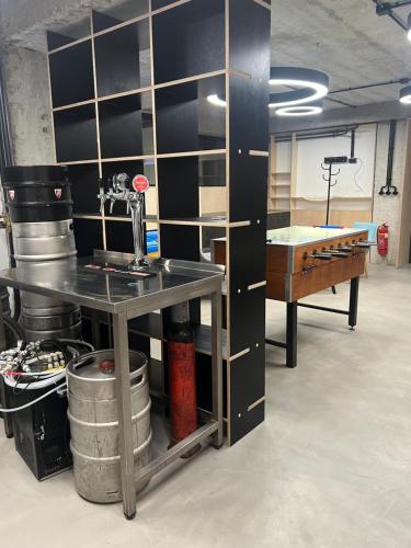 a room with a counter and a table in a room at Vibe Loft free drink daily by Zazi in Bratislava