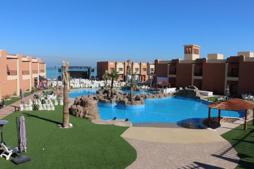 a view of a resort with a large swimming pool at Aquamarine Kuwait Resort(Families Only) in Al Nuwaiseeb