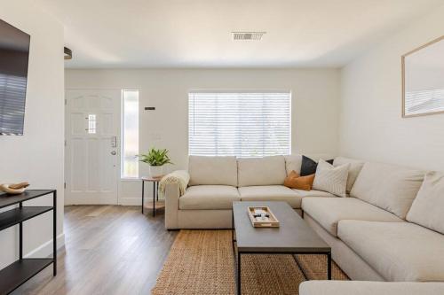 a white living room with a couch and a table at Leucadia's Beach House w Game Room in Encinitas