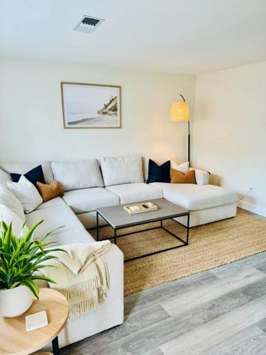 a living room with a white couch and a table at Leucadia's Beach House w Game Room in Encinitas