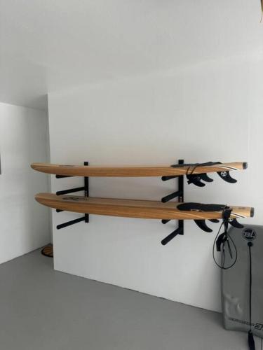 a wooden bench against a white wall at Leucadia's Beach House w Game Room in Encinitas