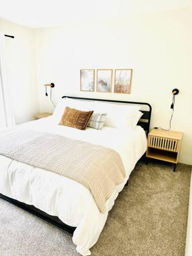 a bedroom with a large white bed with two lamps at Leucadia's Beach House w Game Room in Encinitas