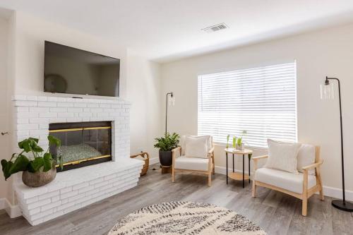 a living room with a fireplace and a tv at Leucadia's Beach House w Game Room in Encinitas