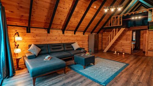 a living room with a couch and a table at Sapanca Ravine Bungalow in Sapanca