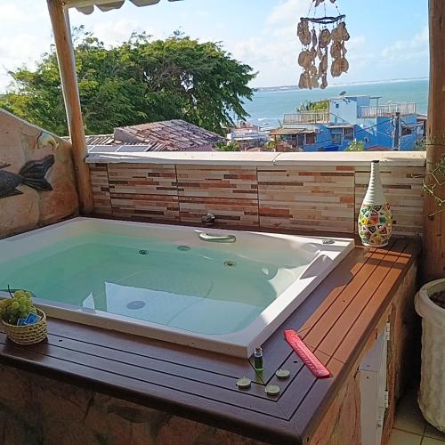 a jacuzzi tub sitting on top of a deck at Flats Mundos Pipa in Pipa
