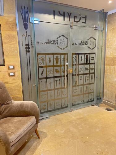 a room with a glass door with signs on it at Mirage pyramids view hotel in Cairo