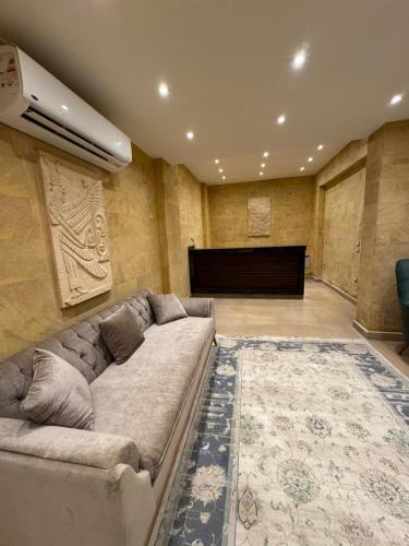 a living room with a couch and a piano at Mirage pyramids view hotel in Cairo
