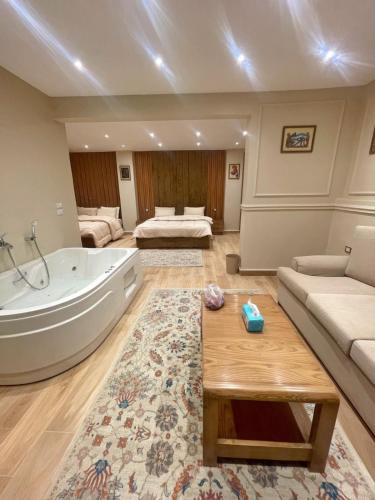 a large bathroom with a tub and a couch at Mirage pyramids view hotel in Cairo