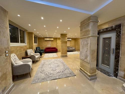 a lobby with a living room with a fireplace at Mirage pyramids view hotel in Cairo