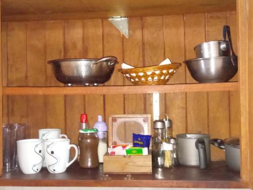 a shelf with bowls and other items on it at Belgrano in San Fernando del Valle de Catamarca