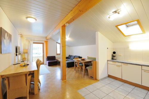 a living room with a kitchen and a dining room at Appartements Lenzikopf in Brand