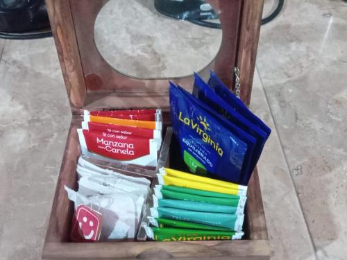 a wooden box filled with different colored books at Belgrano in San Fernando del Valle de Catamarca