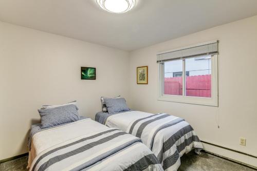 two beds in a room with a window at Anchorage Townhome 2 Mi to Dwtn! in Anchorage