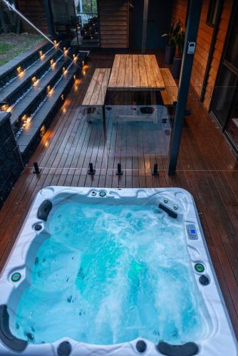 a jacuzzi tub on a deck with lights at The Mountain Chalet - Hot Tub, Fireplace, Games in Eagle Heights