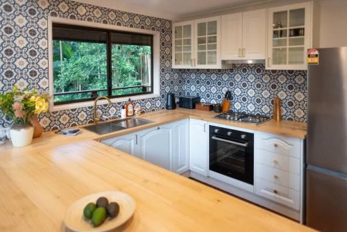 a kitchen with white cabinets and a wooden counter top at The Mountain Chalet - Hot Tub, Fireplace, Games in Eagle Heights