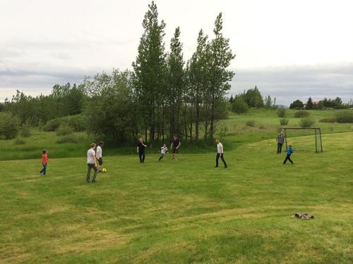 a group of people playing soccer in a field at Villa - South Iceland in Laugaras