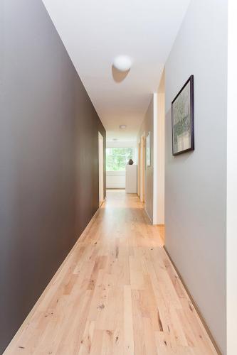 an empty hallway with a wooden floor in a house at Villa - South Iceland in Laugaras