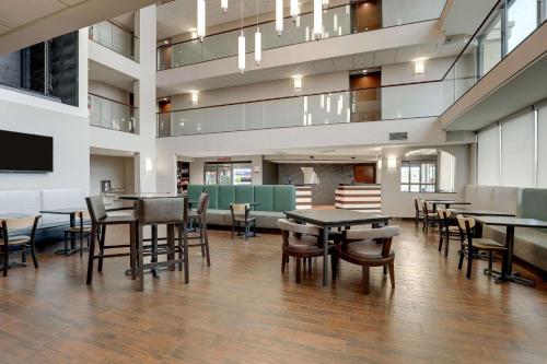 a dining room with tables and chairs in a building at Drury Inn & Suites Cape Girardeau in Cape Girardeau