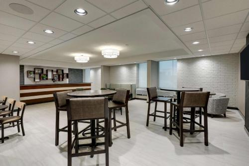 a waiting room with tables and chairs in a building at Drury Inn & Suites Cape Girardeau in Cape Girardeau