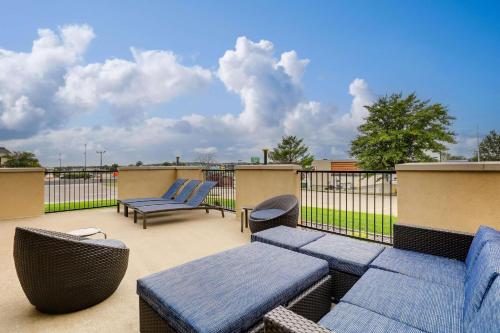 a patio with blue benches and chairs on a balcony at Drury Inn & Suites Cape Girardeau in Cape Girardeau