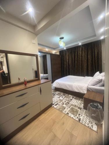 a bedroom with a bed and a large mirror at المهندسين ميدان لبنان in Cairo