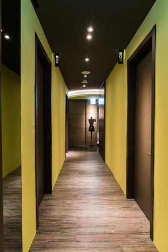 a corridor of an office with yellow walls and wooden floors at Taipei Discover Hostel in Taipei