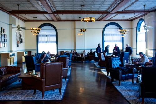 a room with people sitting in chairs in a restaurant at Hotel St. Michael, BW Premier Collection in Prescott