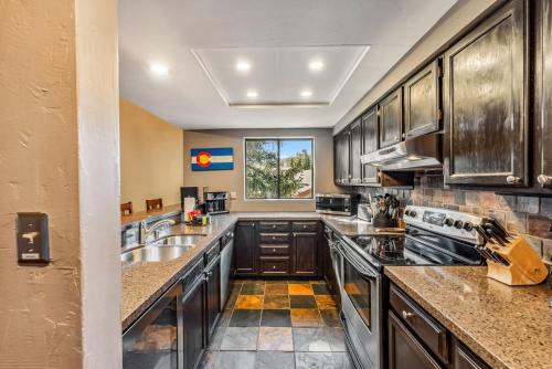 a large kitchen with stainless steel appliances and a window at Rocky Mountain Mama in Breckenridge